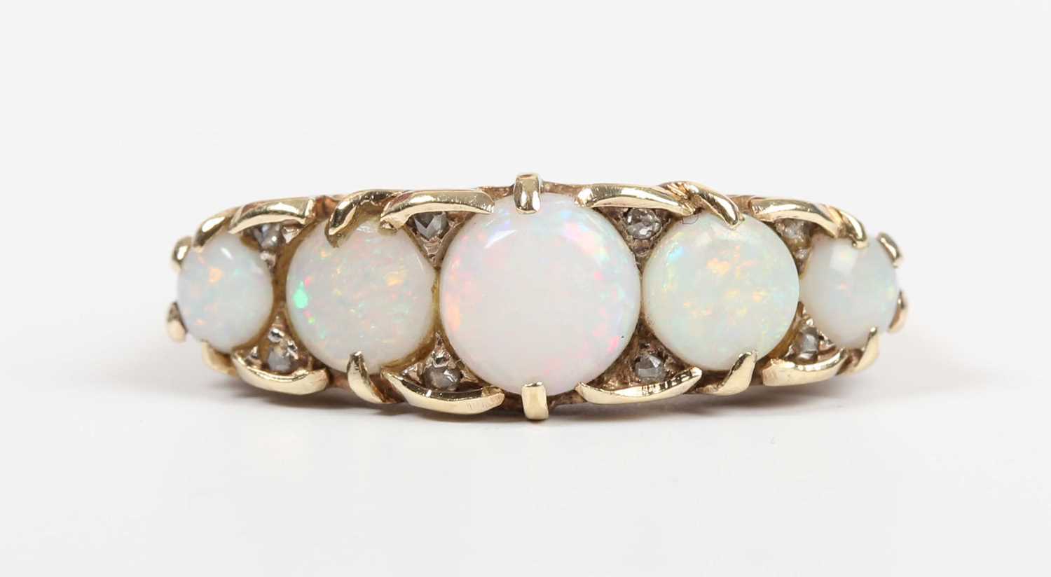 A gold, opal and diamond ring, mounted with a row of five graduated circular opals with four pairs - Image 2 of 5