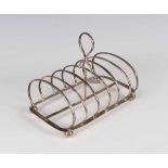 A George IV silver six-division toast rack with central loop handle, on ball feet, Sheffield 1827,