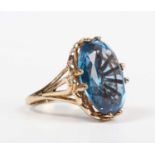 A 9ct gold ring, claw set with a large oval cut synthetic blue spinel, London 2009, weight 9g,