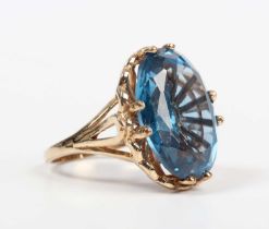 A 9ct gold ring, claw set with a large oval cut synthetic blue spinel, London 2009, weight 9g,