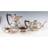 A George V silver three-piece tea set, each piece of cushion shaped half spiral reeded form,