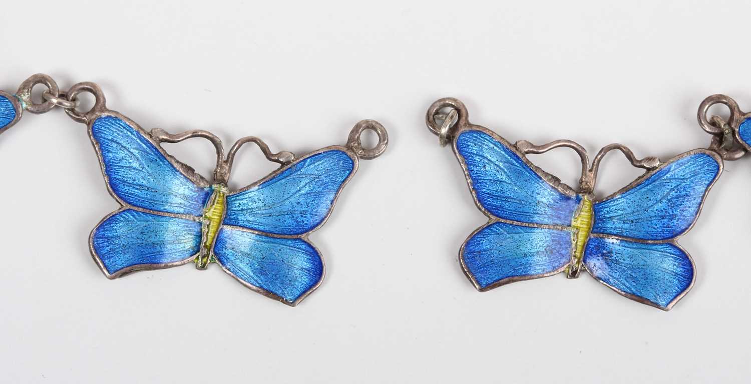 A silver and blue enamelled necklace designed as a row of five butterflies, detailed '925', on a - Image 4 of 4