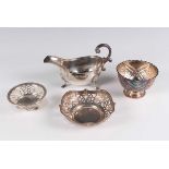 A small group of silver, comprising a sauce boat with beaded rim, London 1973, a sugar bowl,