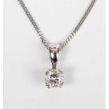 An 18ct white gold and diamond single stone pendant, claw set with a circular cut diamond, weight