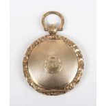 An early 19th century gold back and front circular pendant locket with engine turned decoration