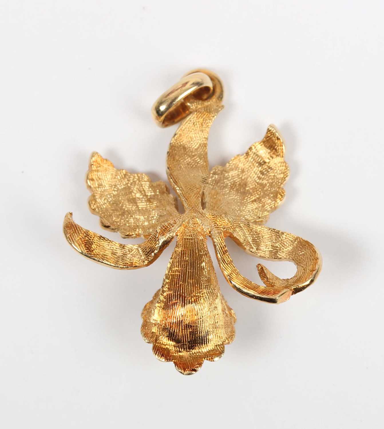 A gold and emerald pendant designed as an orchid flowerhead, claw set with a rectangular step cut - Image 2 of 2