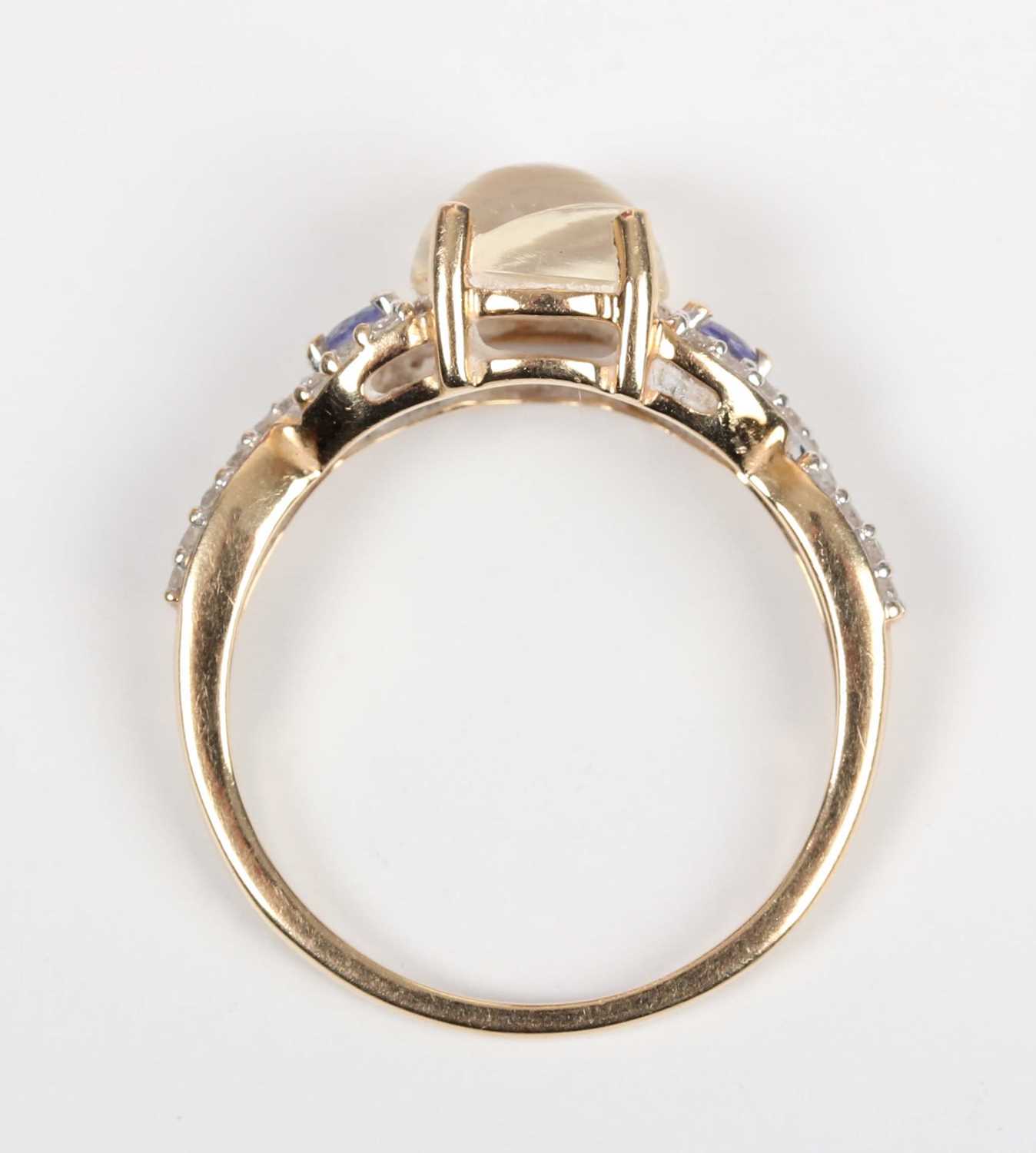 A 14ct gold ring, mounted with a central cabochon pale yellow opal between diamond and pale blue gem - Image 4 of 5