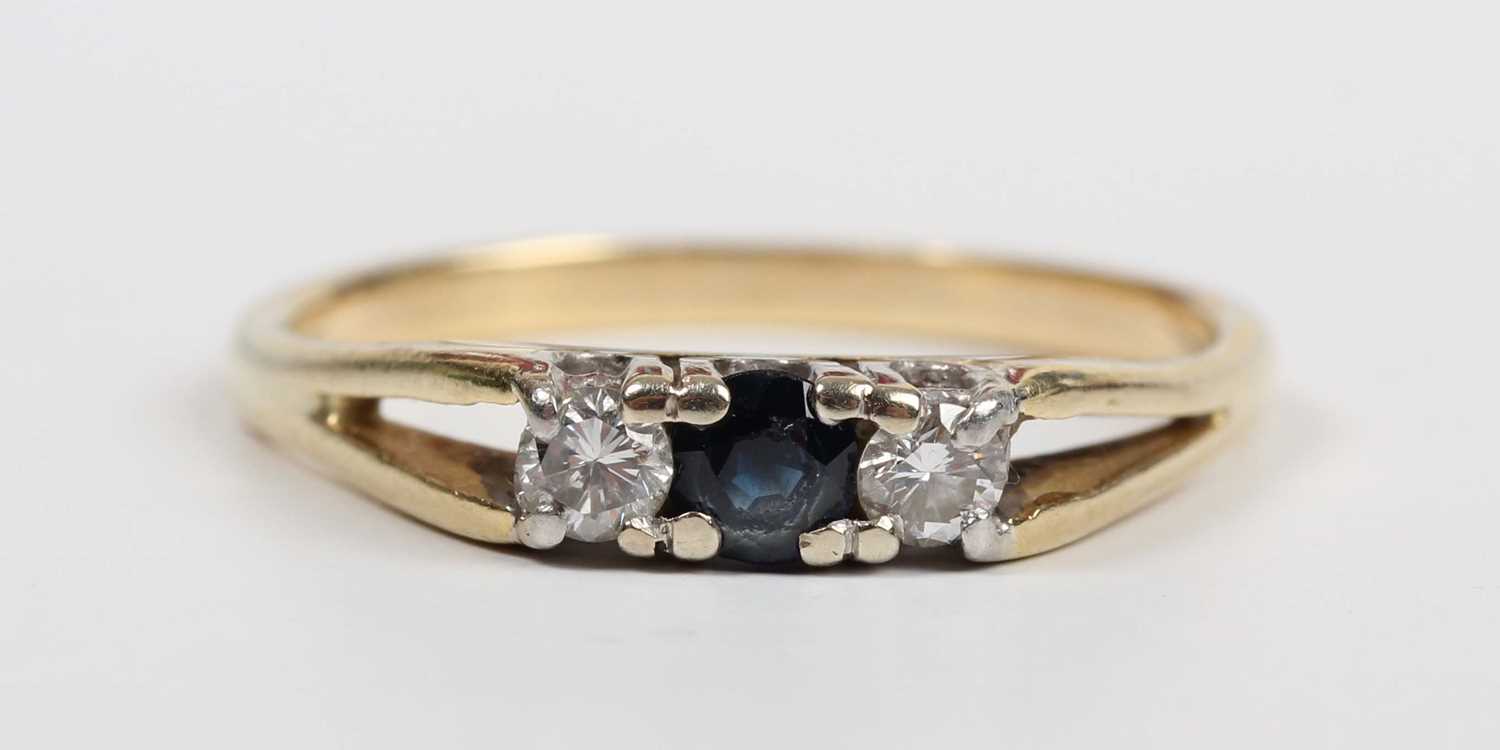 A gold, sapphire and diamond ring, mounted with a circular cut sapphire between two circular cut - Image 4 of 5