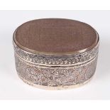 An Islamic silver oval box, the hinged lid inset with an agate panel finely incised with a