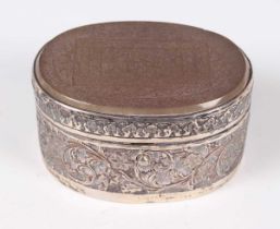 An Islamic silver oval box, the hinged lid inset with an agate panel finely incised with a