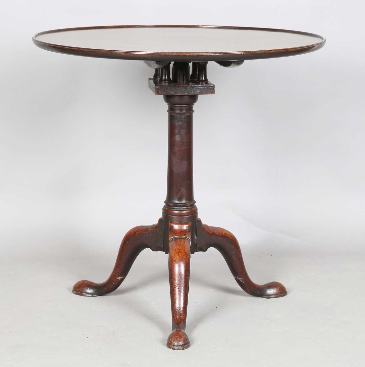 An early George III mahogany circular tip-top supper table with a birdcage mount and turned stem,