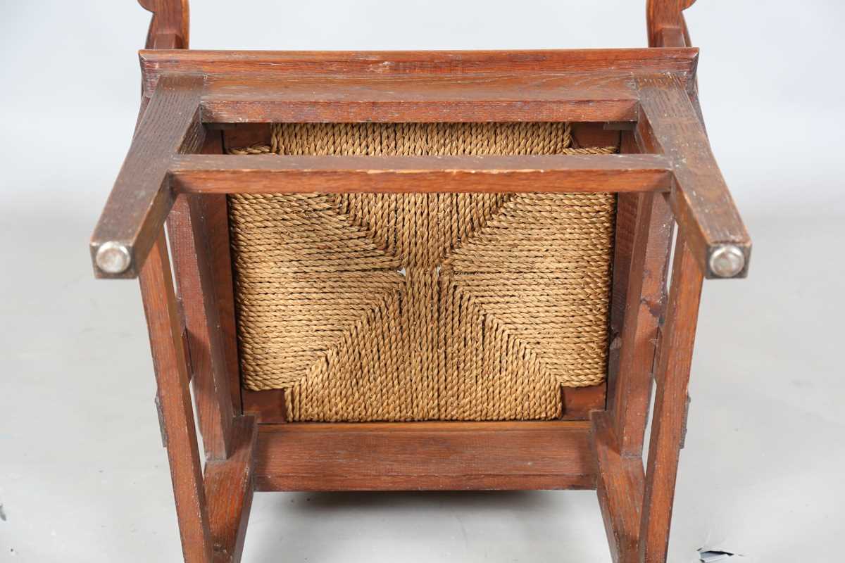 An early 20th century oak framed Orkney armchair, the curved woven straw back and string seat raised - Image 14 of 14