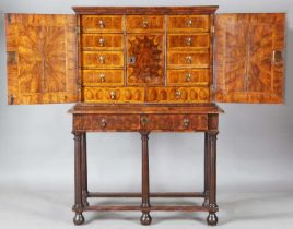 A William and Mary laburnum oyster veneered collector's cabinet-on-stand, the two doors with