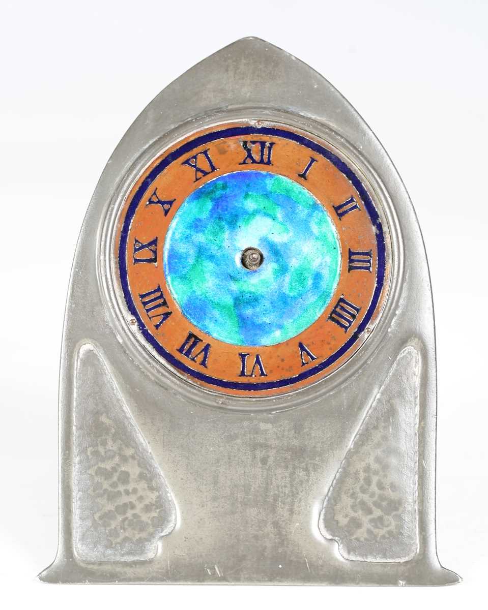 A Liberty & Co 'Tudric' pewter timepiece, model number '0975', the lancet arched front with a blue/