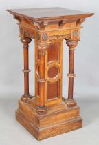 A large late Victorian Gothic Revival oak pedestal, the frieze carved with rosette medallions