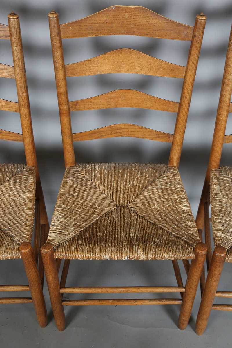 A set of six early 20th century Arts and Crafts ash framed ladder back chairs, in the manner of - Image 12 of 15