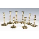A pair of early 18th century brass candlesticks with knop stems and spiral reeded bases, height