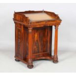 A William IV rosewood Davenport, the galleried top with a hinged writing slope above fluted supports