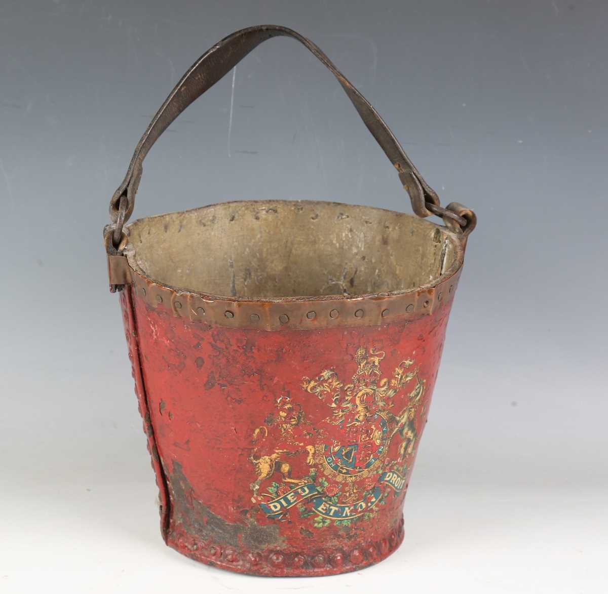 A late 18th/19th century painted leather fire bucket with strap handle and transfer printed royal