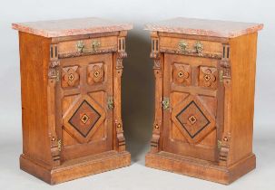 A pair of late Victorian Aesthetic Movement oak cabinets, in the manner of Charles Bevan, the