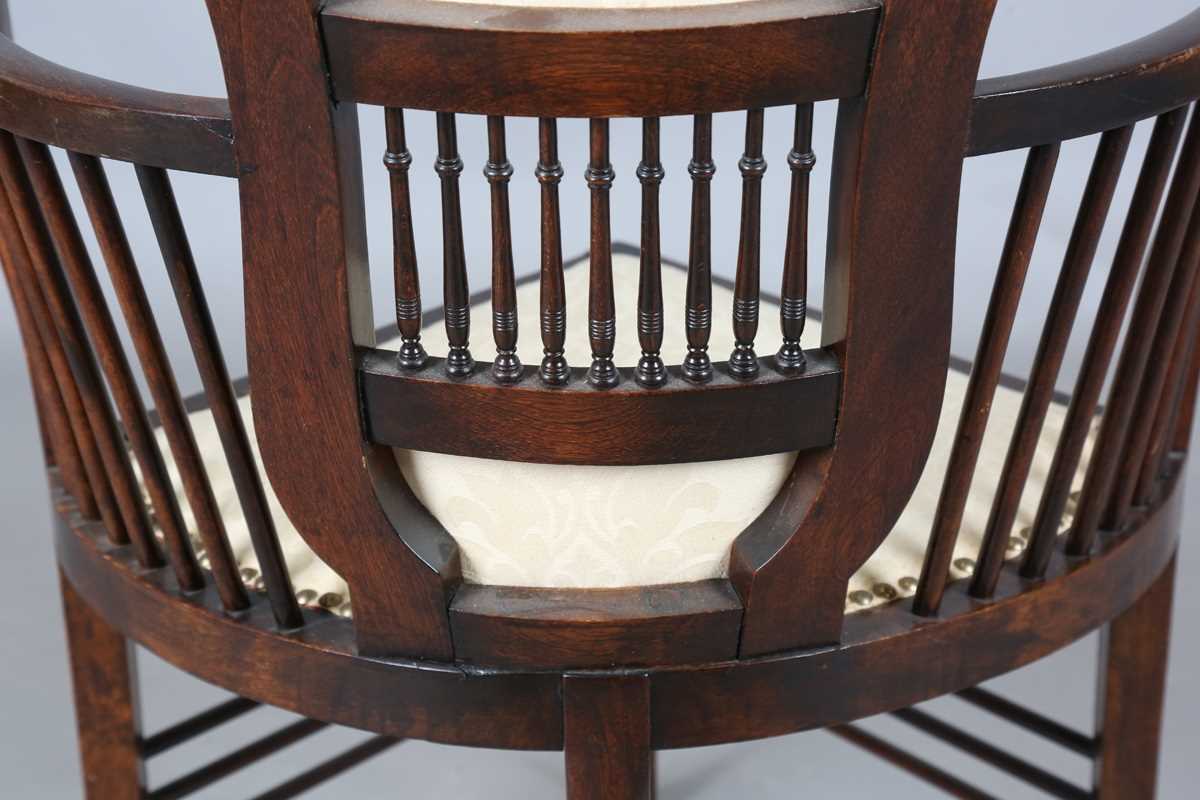 An Edwardian Arts and Crafts style stained walnut showframe armchair, upholstered in cream fabric, - Image 15 of 17