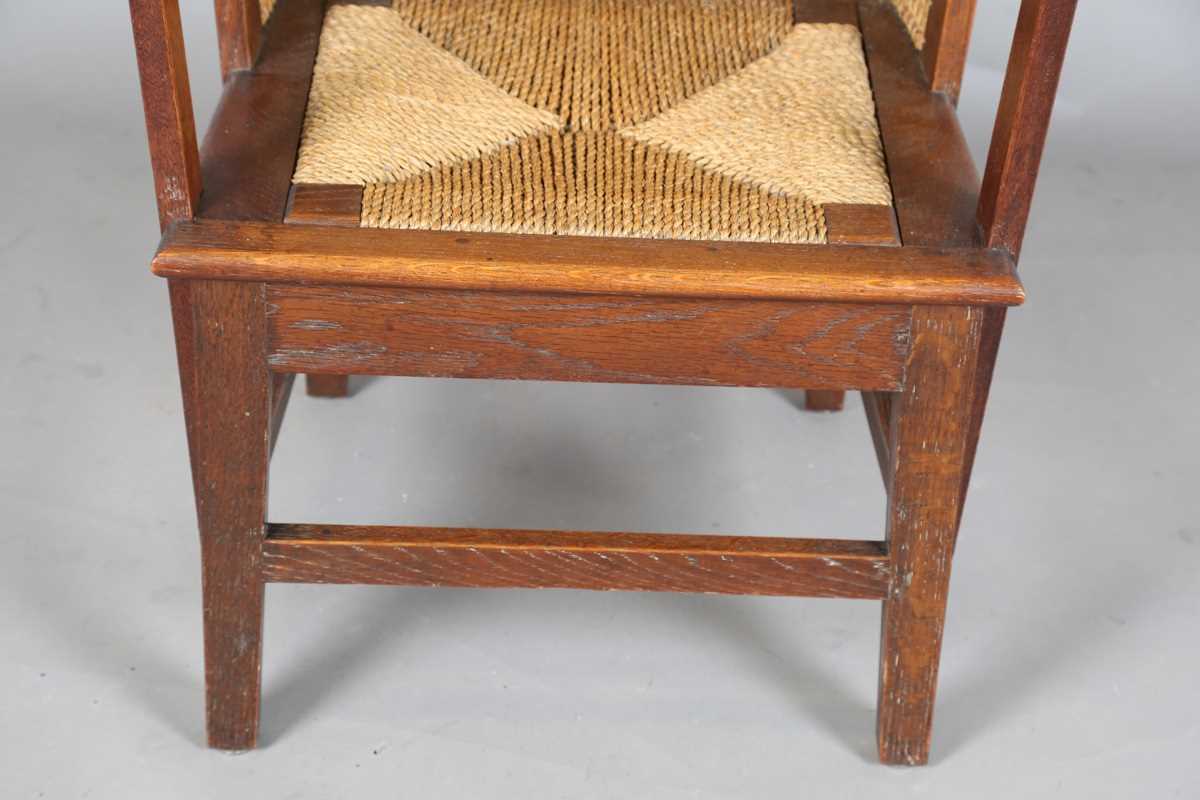 An early 20th century oak framed Orkney armchair, the curved woven straw back and string seat raised - Image 5 of 14
