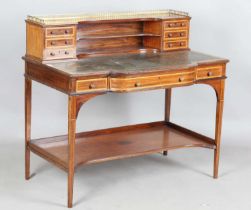 An Edwardian mahogany and satinwood crossbanded writing table, the frieze back fitted with