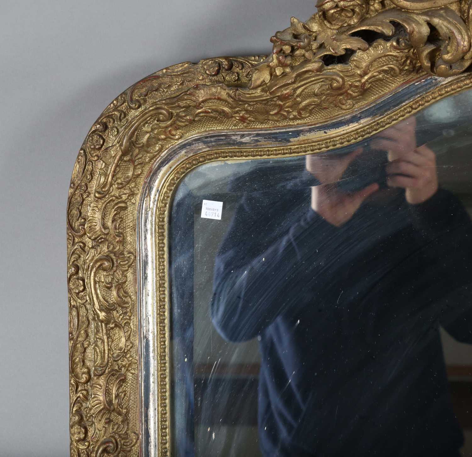 A late 19th century gilt composition arched overmantel mirror with a foliate scroll surmount and - Image 13 of 15