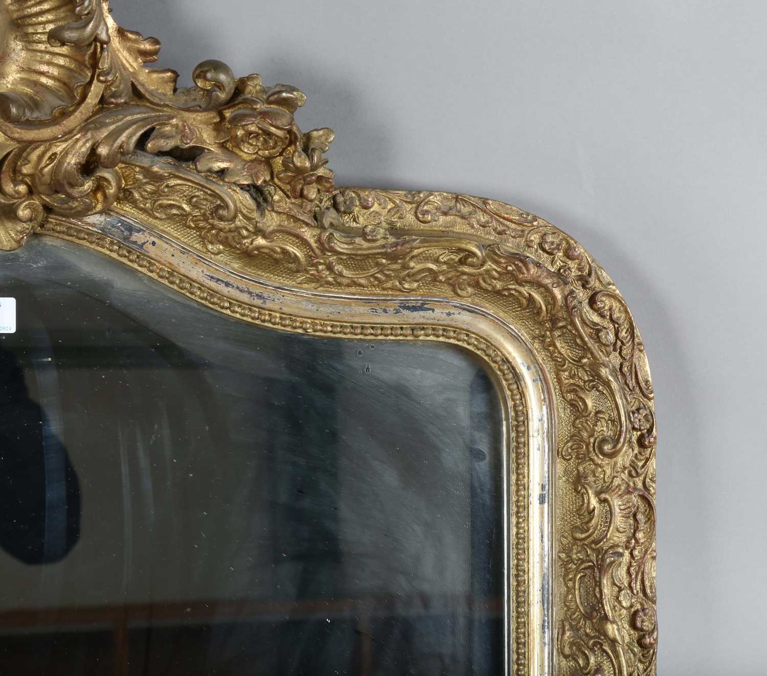 A late 19th century gilt composition arched overmantel mirror with a foliate scroll surmount and - Image 4 of 15