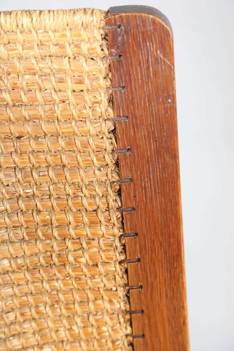 An early 20th century oak framed Orkney armchair, the curved woven straw back and string seat raised - Image 9 of 14
