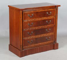 A late 20th century reproduction mahogany chest of drawers, crossbanded in yew, the four long