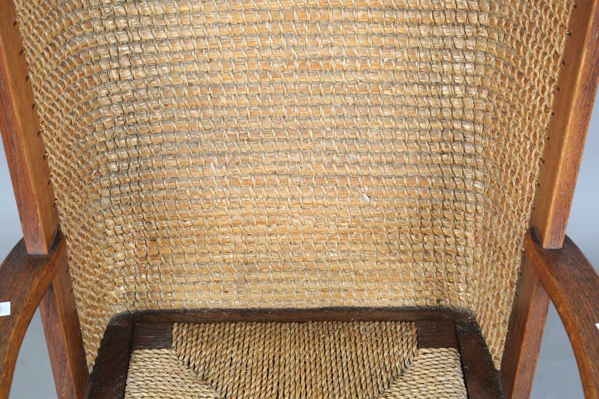 An early 20th century oak framed Orkney armchair, the curved woven straw back and string seat raised - Image 3 of 14