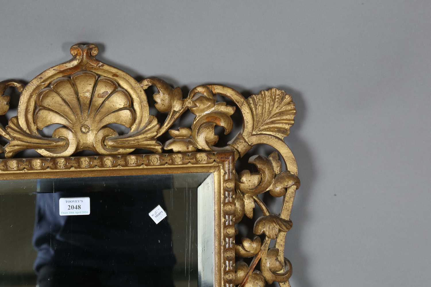 An early 20th century Continental giltwood wall mirror with a carved foliate frame and bevelled - Image 3 of 9