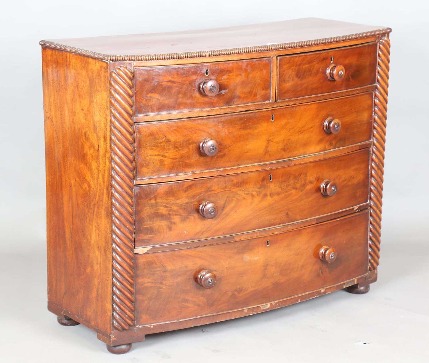 A Victorian mahogany bowfront chest of drawers with reeded pilasters and squat bun feet, height