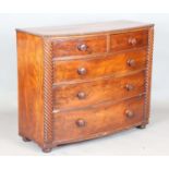A Victorian mahogany bowfront chest of drawers with reeded pilasters and squat bun feet, height