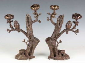 A pair of 20th century brown patinated cast bronze twin-light candelabra, probably Japanese, the