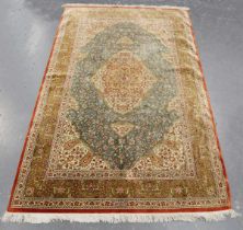 A fine Qum silk rug, signed, Central Persia, late 20th century, the deep celadon field with a shaped