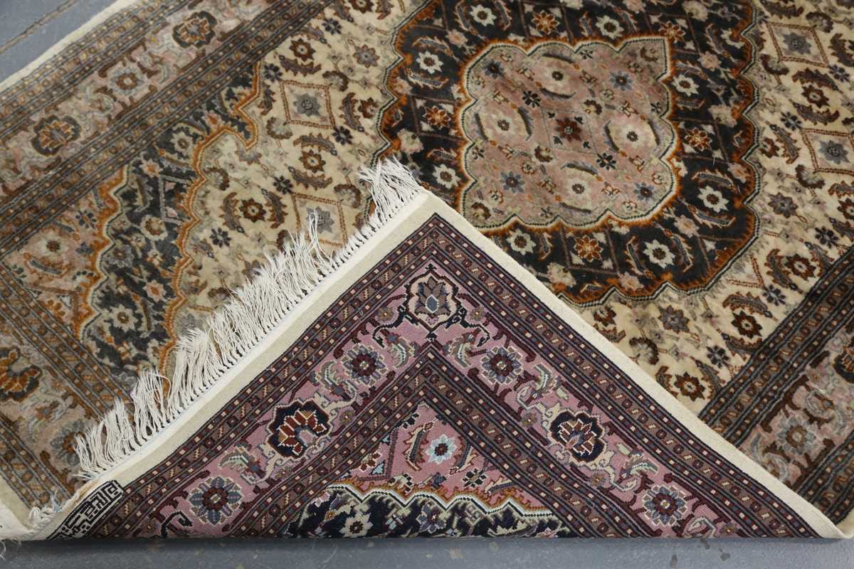 A Kashmir rug, signed, late 20th century, the cream field with a shaped medallion, within a palmette - Image 6 of 6