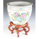 A Chinese porcelain jardinière, painted with flowers and black calligraphy, height 33cm, diameter