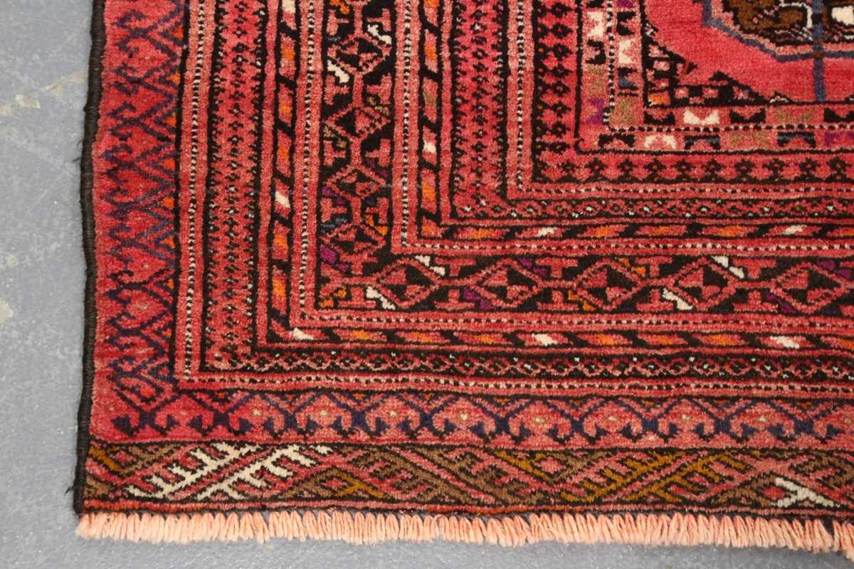 A Turkestan rug, late 20th century, the pale claret field with three columns of guls, within a - Image 5 of 7