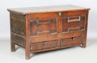 A late 17th century oak mule chest, the hinged lid above a panelled front and two drawers, height