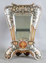 A French Art Nouveau silvered and painted dressing table mirror of shaped outline, decorated with