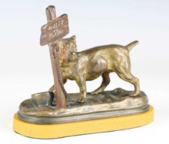 A late 19th century Continental patinated cast bronze model of a dog chained to an inscribed sign