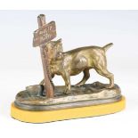 A late 19th century Continental patinated cast bronze model of a dog chained to an inscribed sign