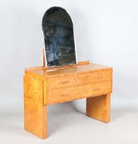 An Art Deco burr maple dressing table, in the manner of Betty Joel, the arched mirror above three