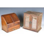 An Edwardian oak table-top cabinet, the two glazed doors enclosing three drawers, width 32cm,