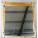 A 20th century reproduction maple and giltwood overmantel mirror with rosette and scroll