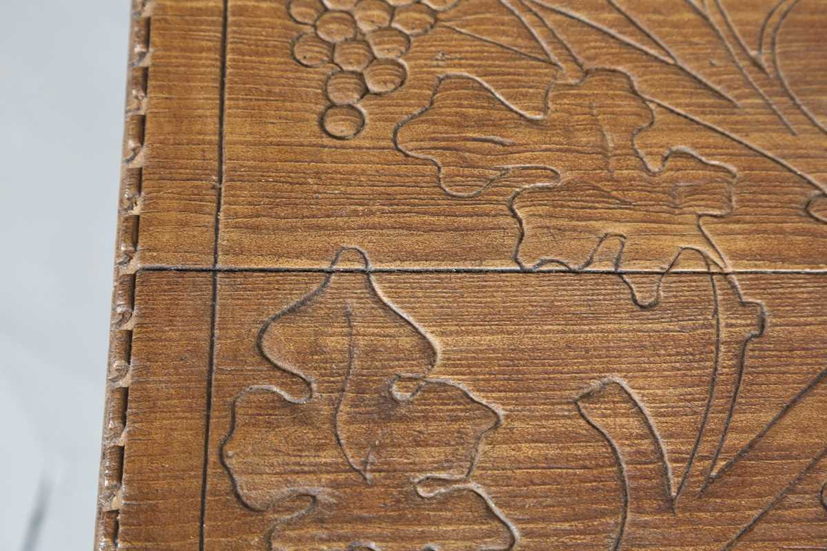 A 20th century Arts and Crafts style carved softwood centre table, the top decorated with wheat - Image 4 of 10