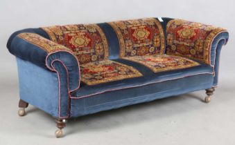 A Victorian Chesterfield settee, upholstered in blue velour and sections of carpet, raised on turned