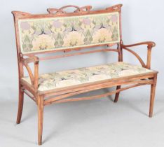 An Art Nouveau stained beech three-piece salon suite with pierced showframe and contemporary fabric,